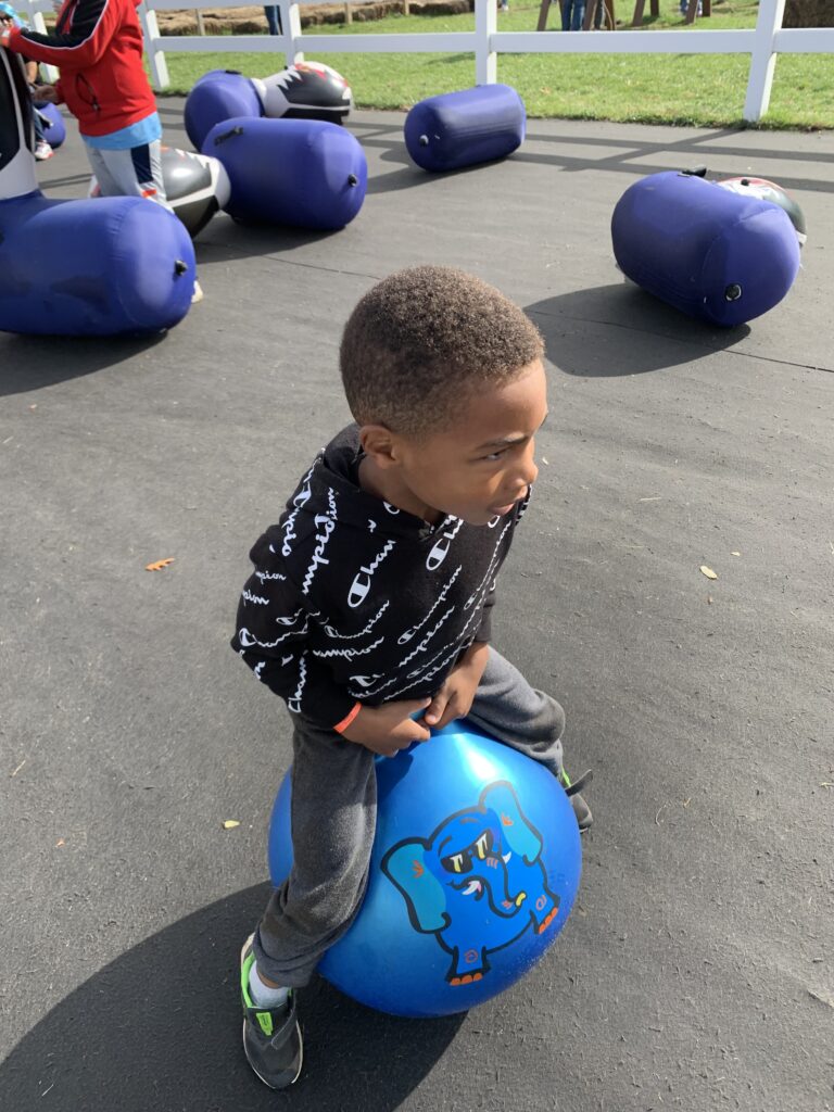 playing with the bouncy horses at Happy Day farm